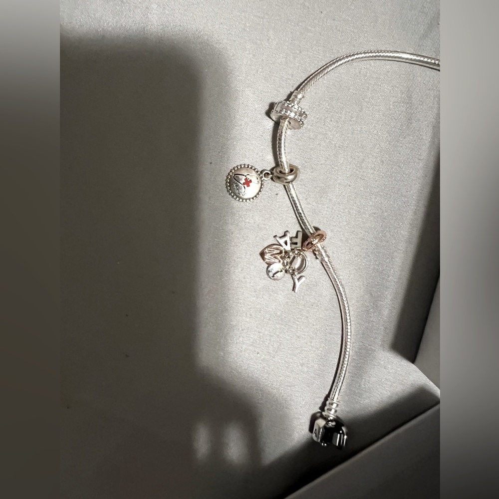 Pandora with nurse, family charms